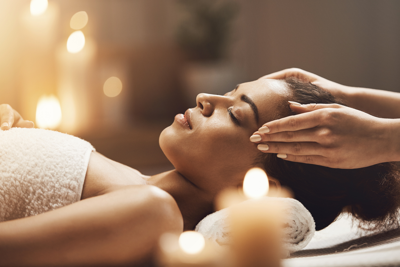 attractive-african-woman-enjoying-face-massage-in-spa-salon-(1)